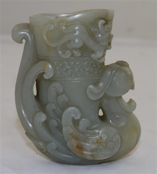 A Chinese archaistic pale celadon jade phoenix rhyton, height 10.2cm